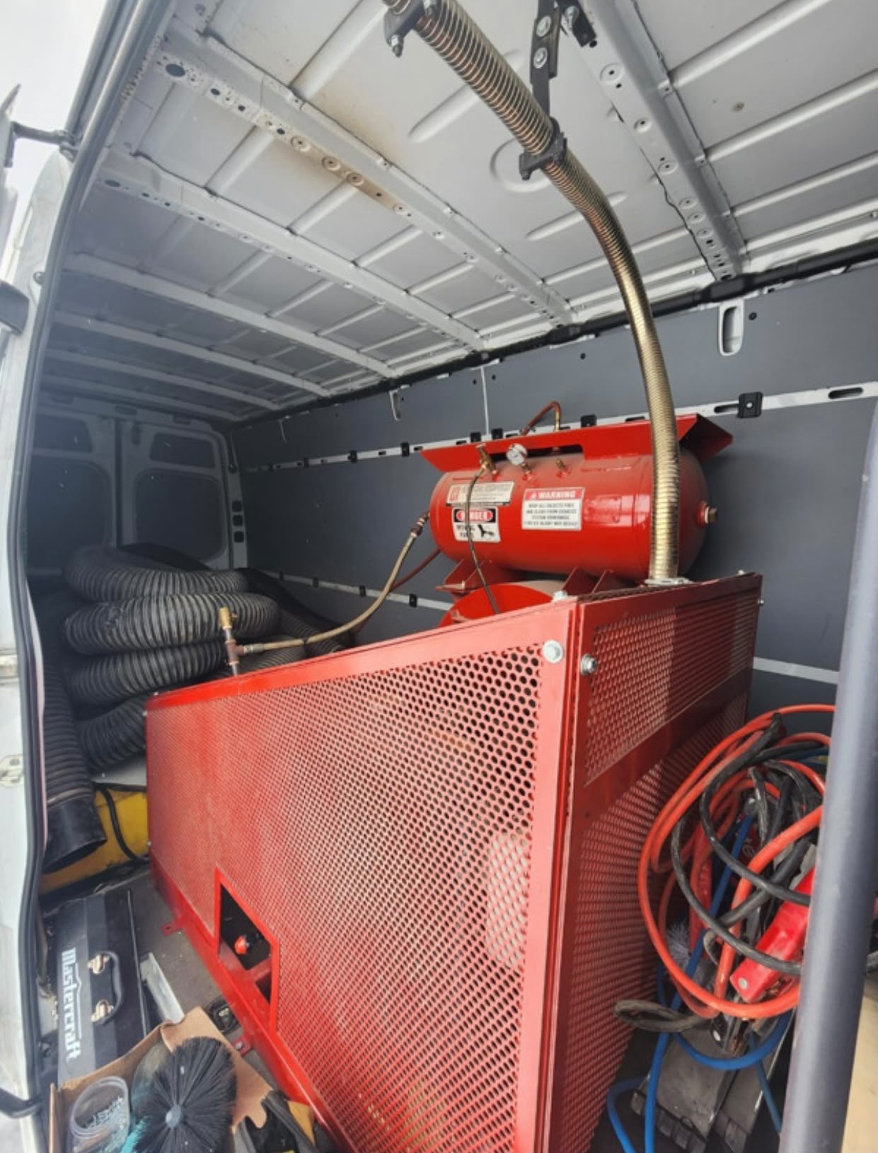 Truck-mounted vacuum equipment inside the service van